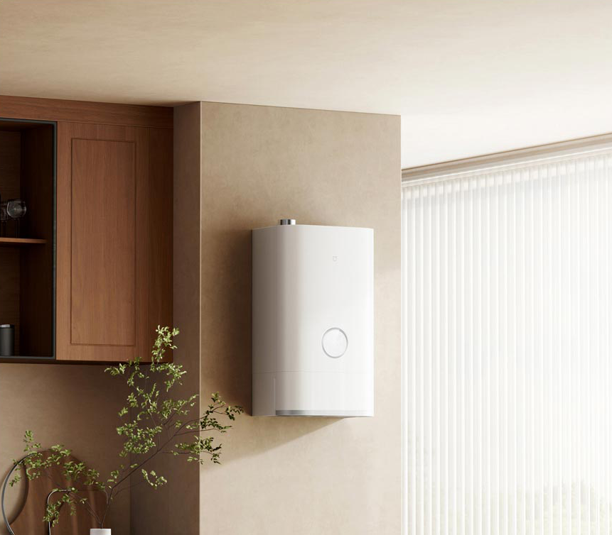 El calentador de agua inteligente Xiaomi Mijia Smart Gas Water Heater Pro instalado en la pared de una cocina o lavadero moderno, mostrando cómo se integra su diseño minimalista en el hogar.