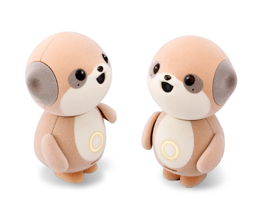 Dos robots Sharp Poketomo idénticos colocados uno frente al otro sobre un fondo blanco, ilustrando su capacidad para interactuar y conversar entre ellos.