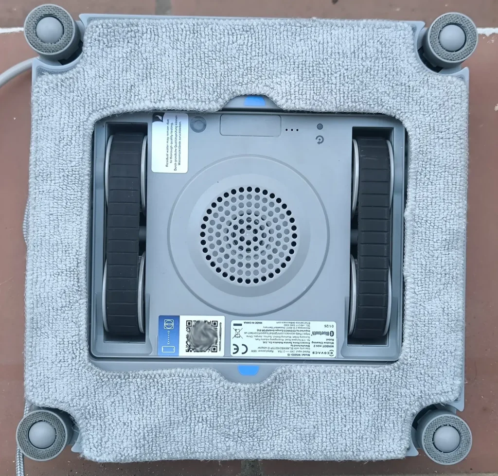 Parte inferior del ECOVACS WINBOT Mini 2 con la almohadilla de microfibra, las ruedas y la etiqueta de especificaciones